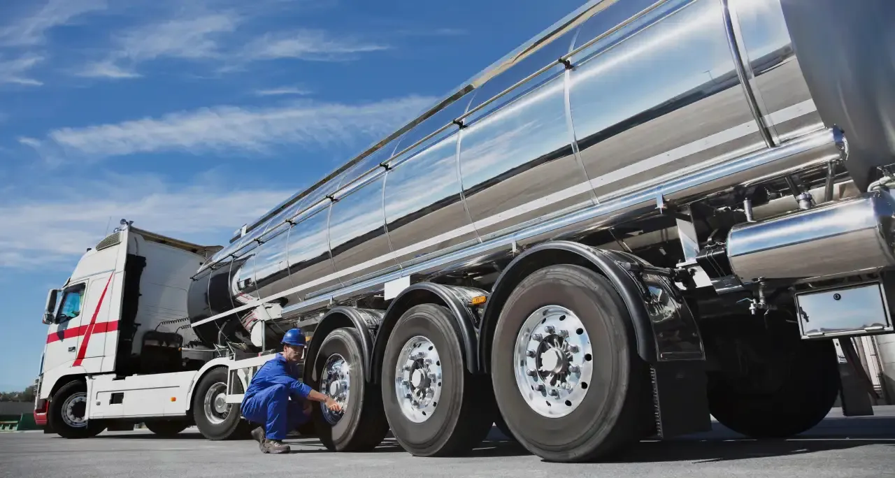 Tanker truck and driver carrying out a pre-trip check